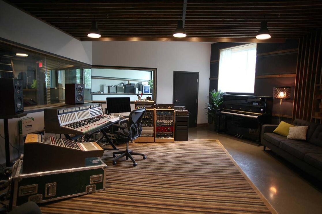 Studio de musique avec un piano et des outils pour des enregistrements.